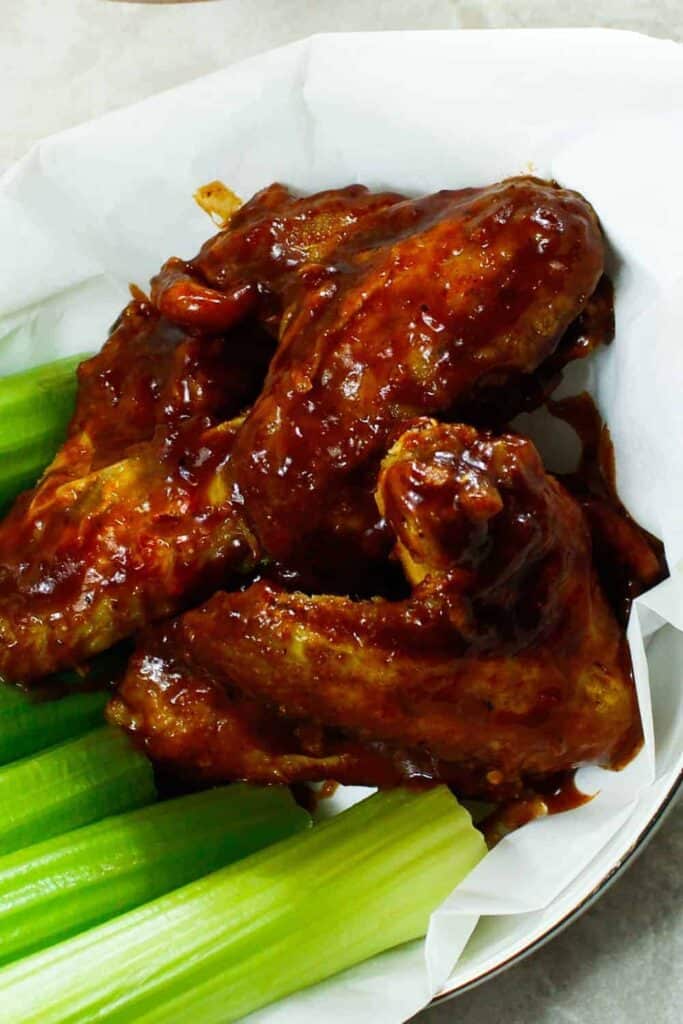 bbq chicken wings in a bowl with celery