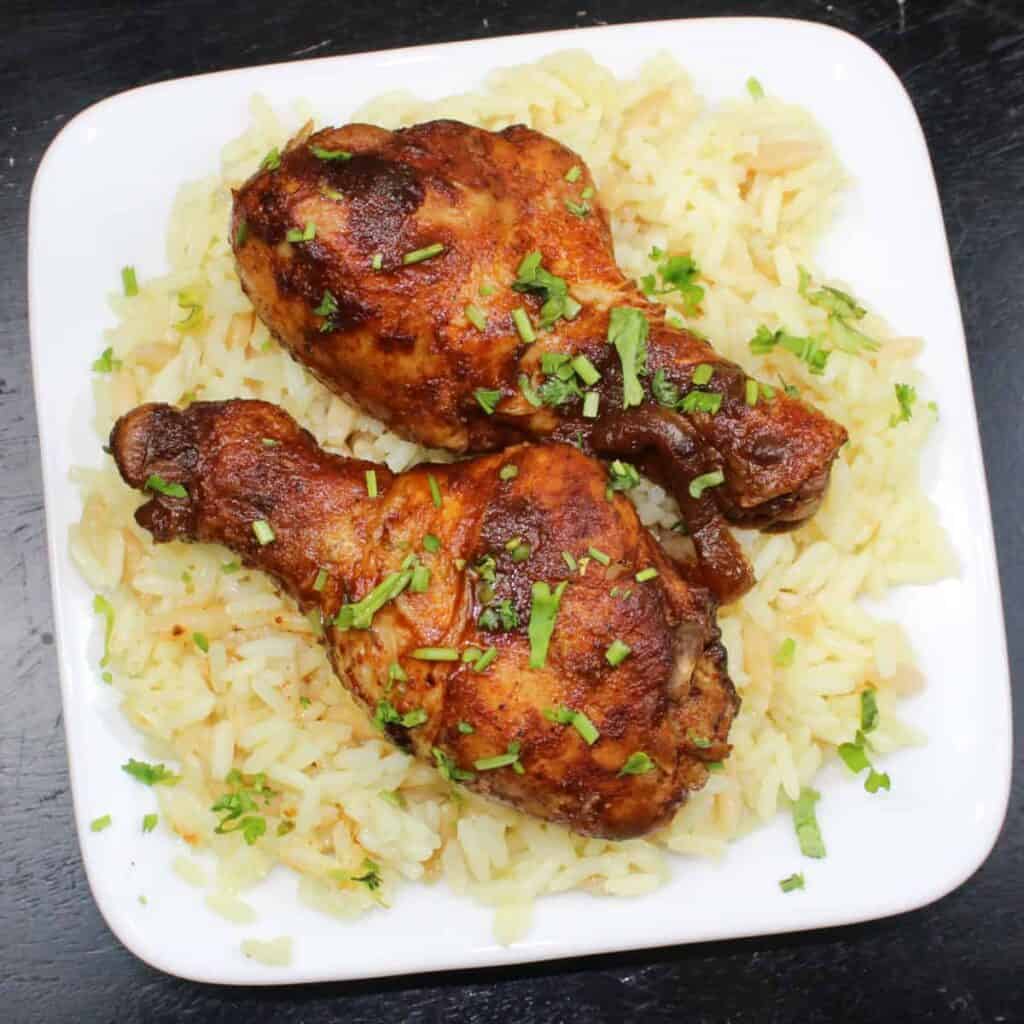 slow cooker bbq chicken on a plate with rice