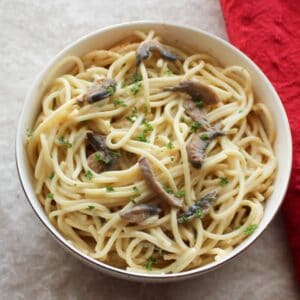 mushroom pasta in a bowl on a fork