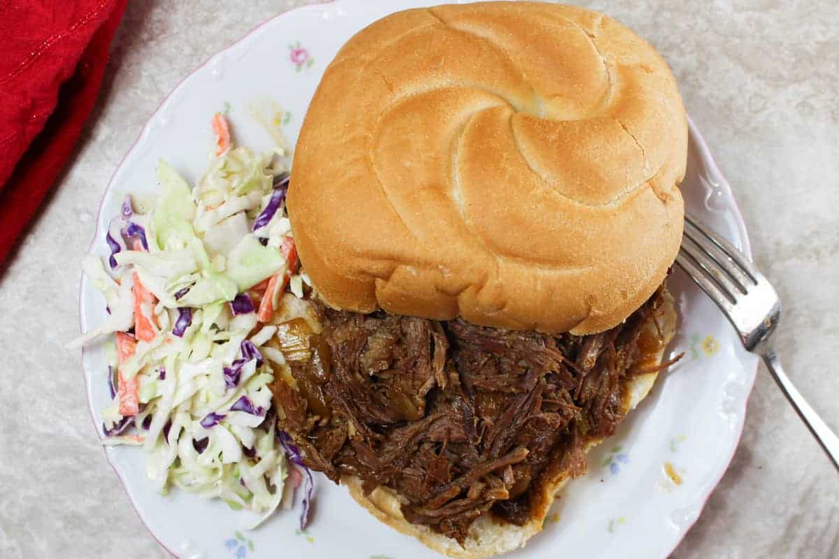 slow cooker bbq beef on a plate with slaw