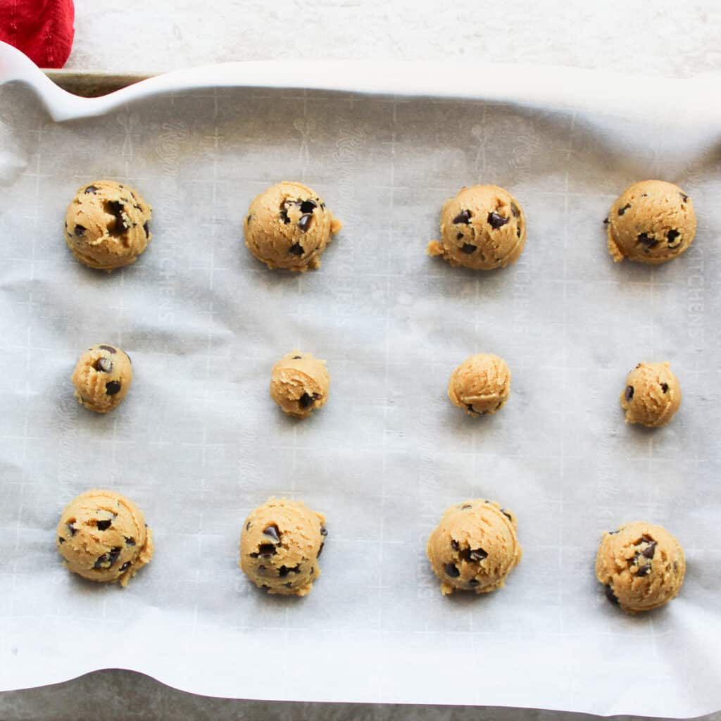 scoop cookie dough onto parchment paper for baking
