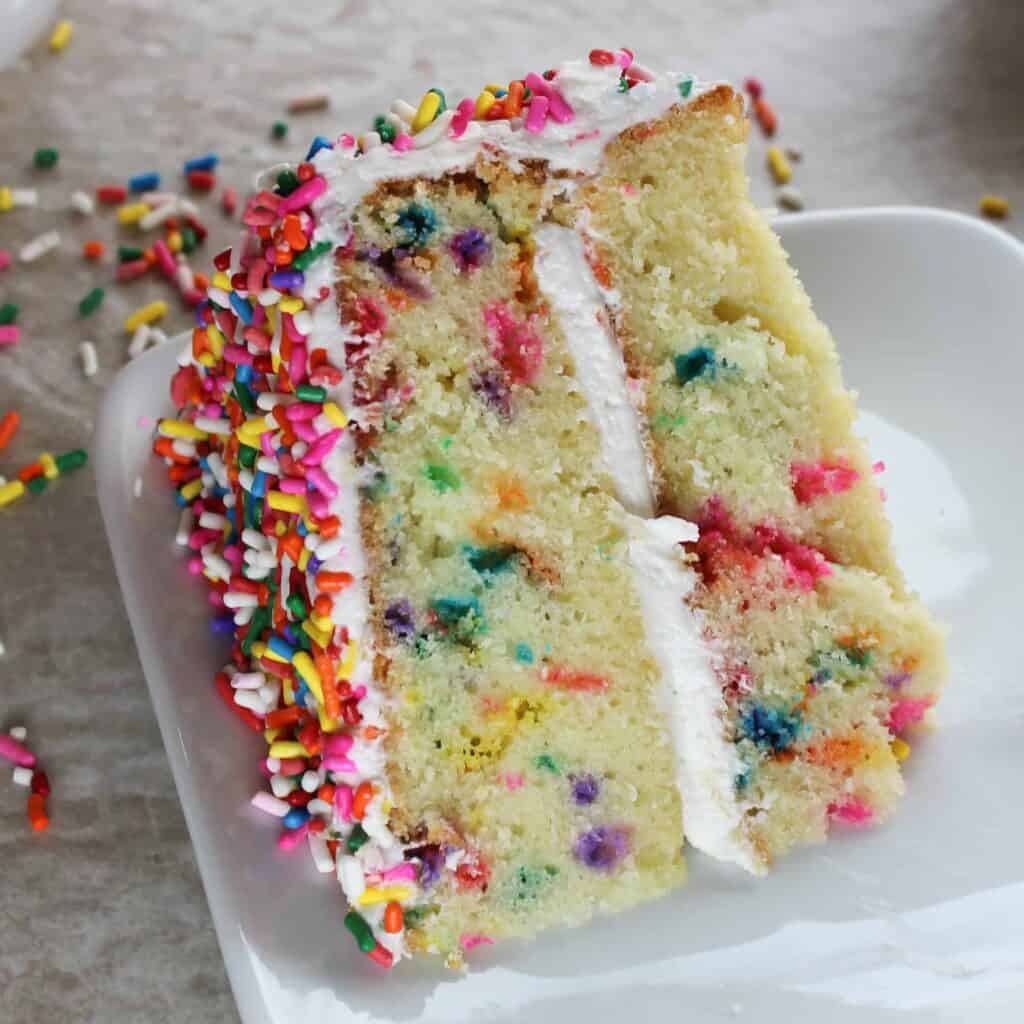 slice of rainbow sprinkle cake