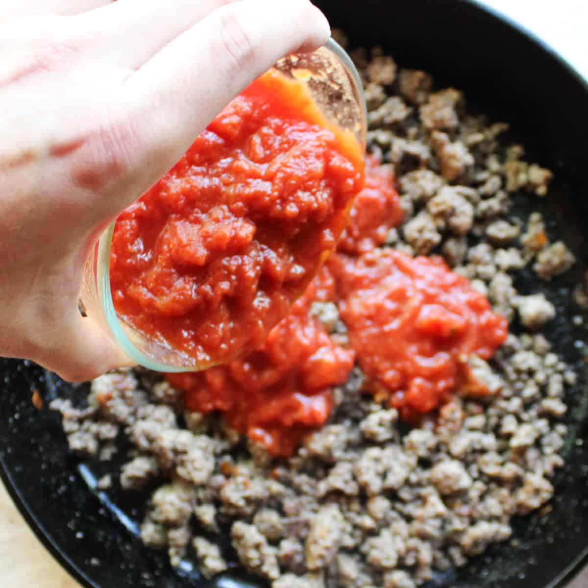 add diced tomatoes to seasoned ground beef