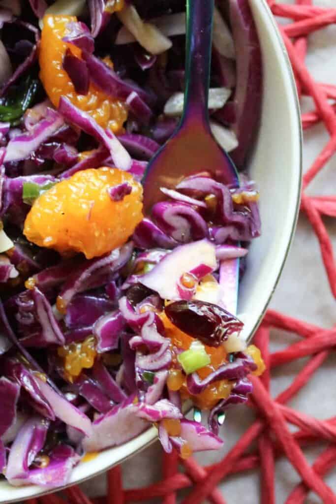 red cabbage salad in a bowl on a fork