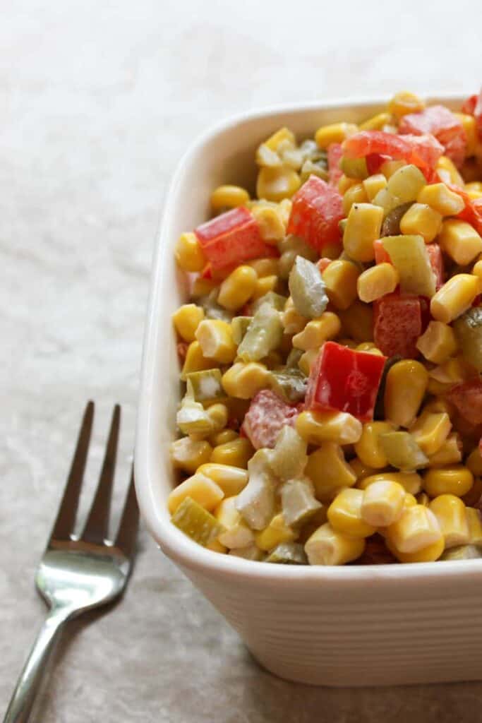 corn salad served in a bowl with a fork on the side