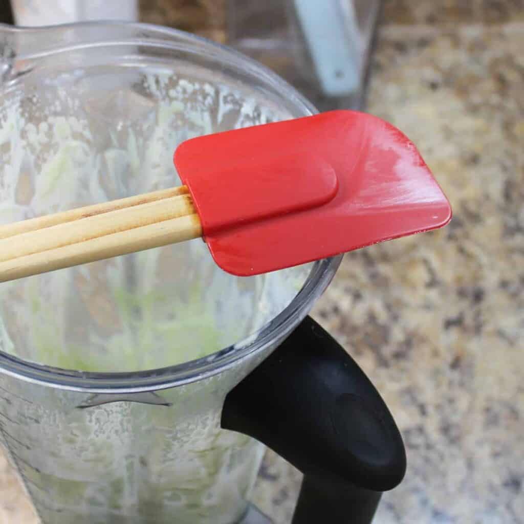green onion dip in a blender with a red spatula