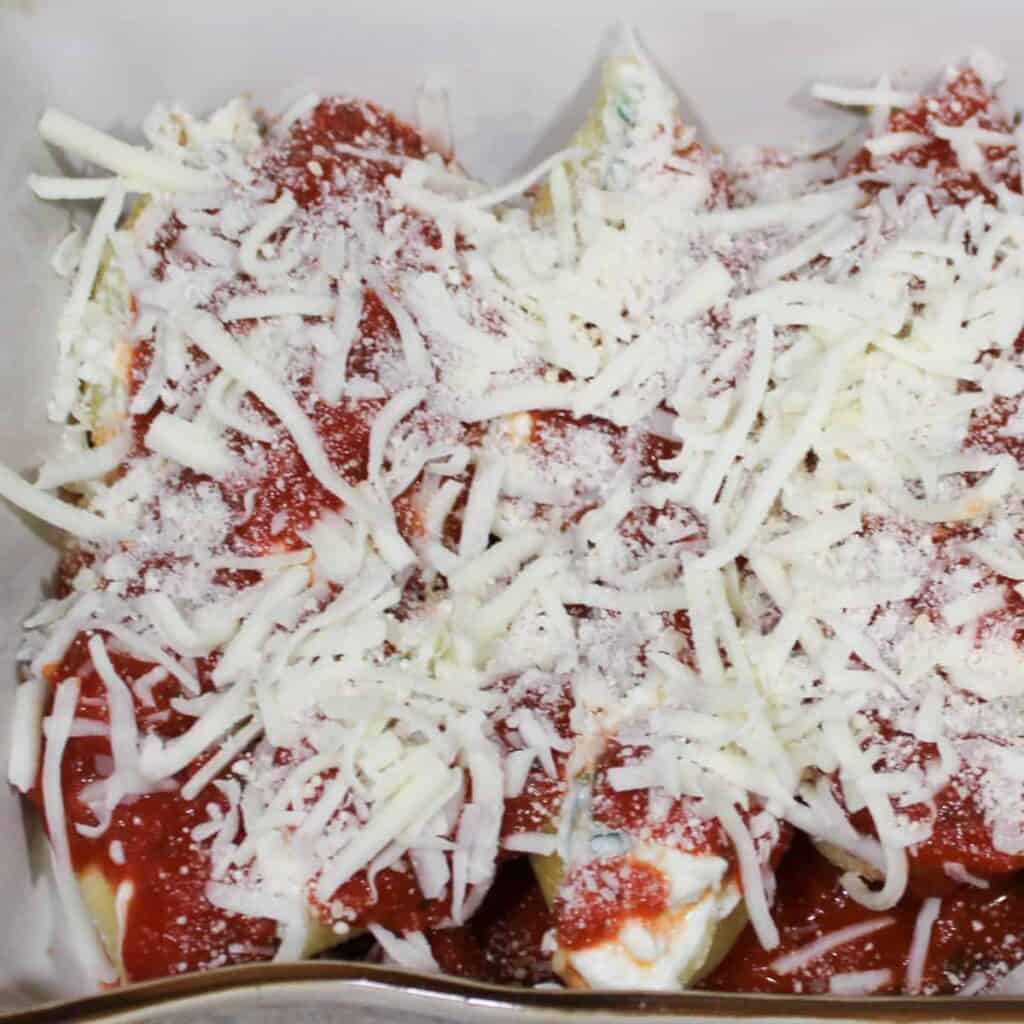 stuffed shells covered with shredded cheese